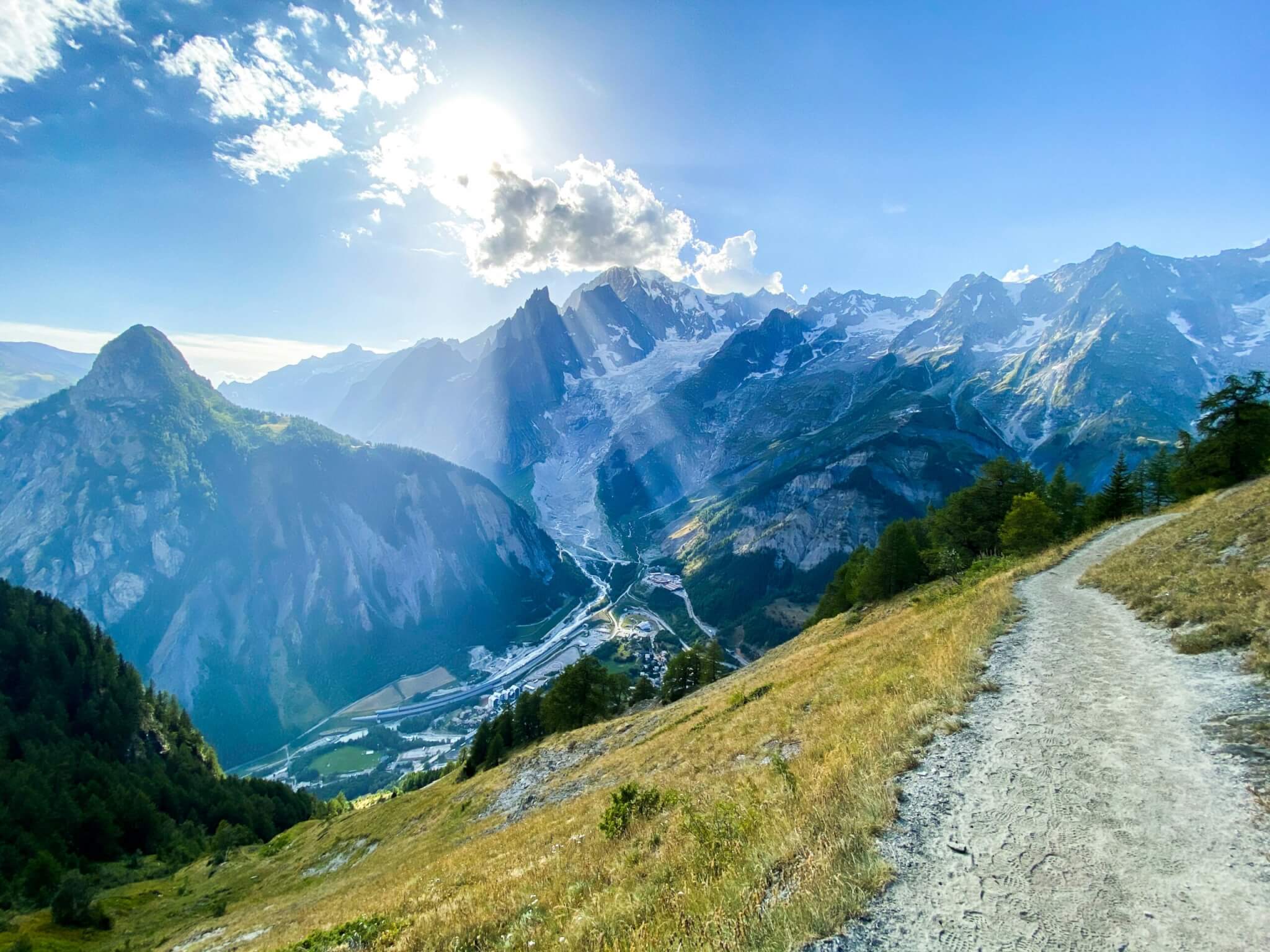 A view of the Swiss Alps, showing high peaks and green valleys.